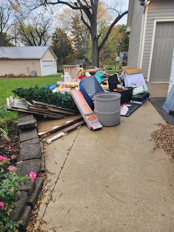Dumpster being loaded with debris for Estate Cleanout Dumpster Rental in Richmond Heights